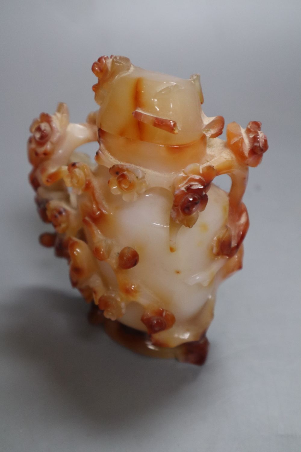A Chinese agate vase and cover and a hardstone tree, in carved celadon jardiniere, 29cm